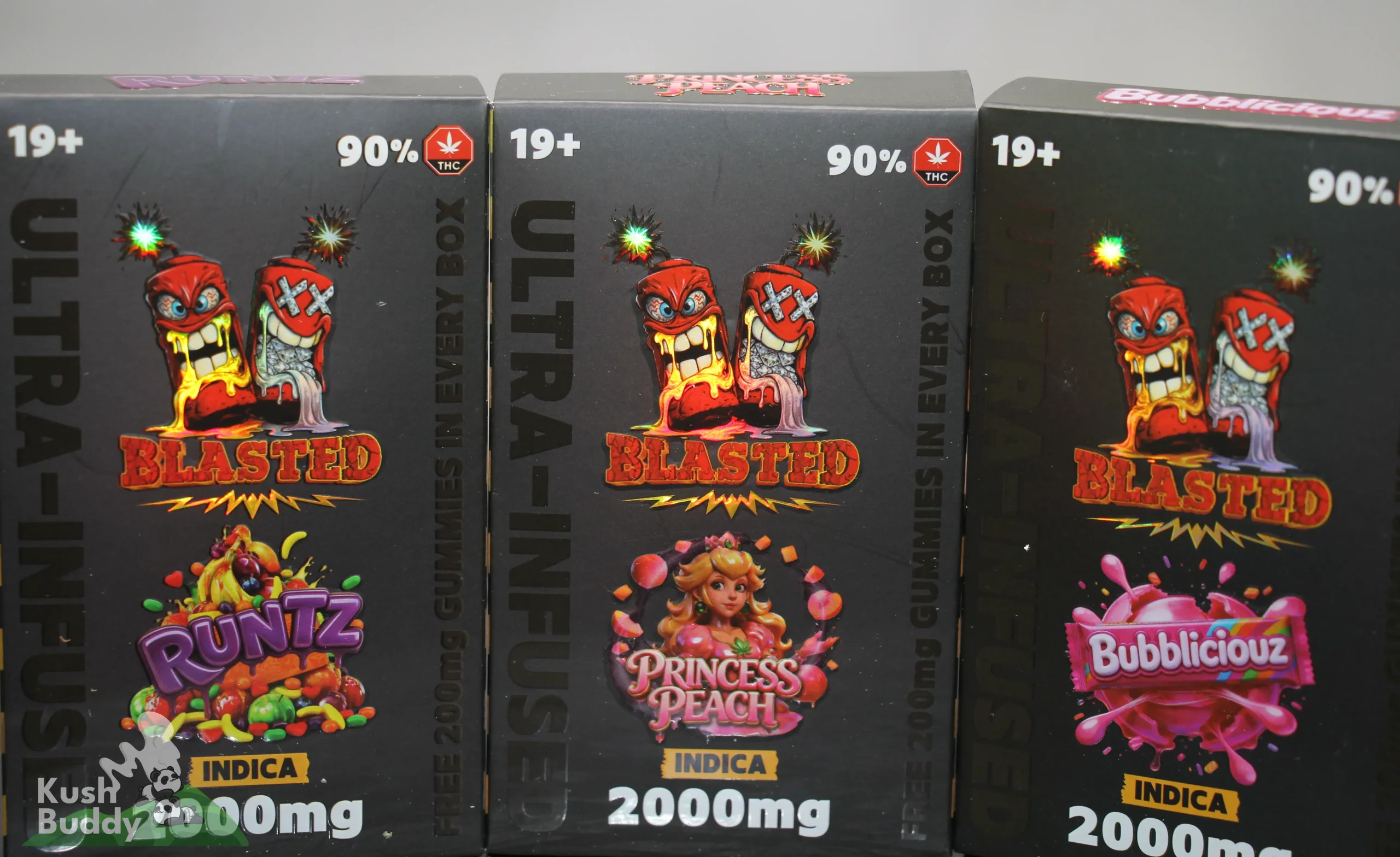 Row of black cannabis product boxes with '90% THC' and 'INDICA' labels, featuring colorful cartoon characters and 'BLASTED' branding on a shelf.