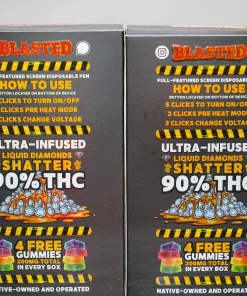 Two black boxes of a cannabis product labeled 'BLASTED' with bold orange text reading 'HOW TO USE' and a pile of colorful gummy-looking shapes, showing '90% THC' and 'ULTRA-INFUSED SHATTER' graphics side by side on a gray background.
