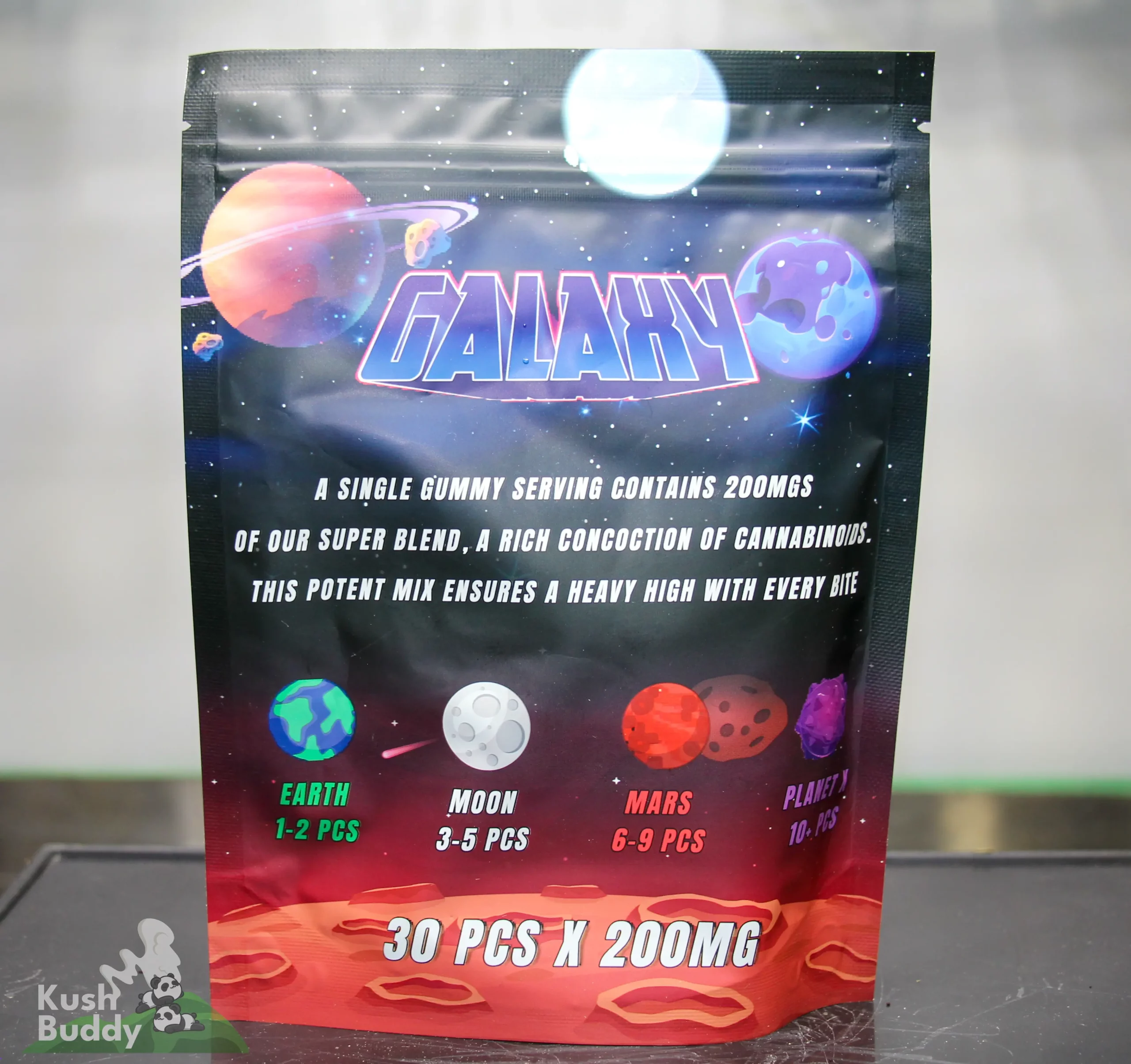 Space-themed gummy package with colorful planets and bold word 'GALAXY' across the front, showing serving size text (e.g., 30 PCS x 200MG).