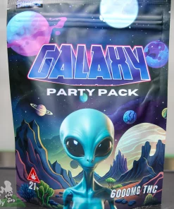 Front of a space‑themed Galaxy Party Pack packaging featuring a blue alien and colorful planets in a cosmic scene.