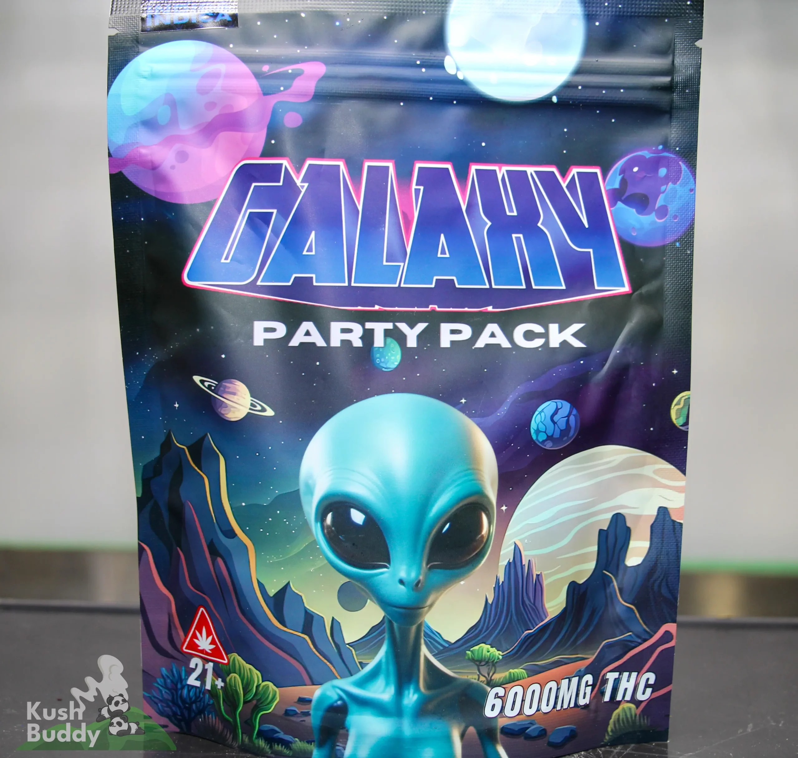 Front of a space‑themed Galaxy Party Pack packaging featuring a blue alien and colorful planets in a cosmic scene.