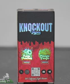 Front-on view of a vape box labeled 'KNOCKOUT Vapes' with holographic lettering, red lower panel, and a QR code toward the bottom.